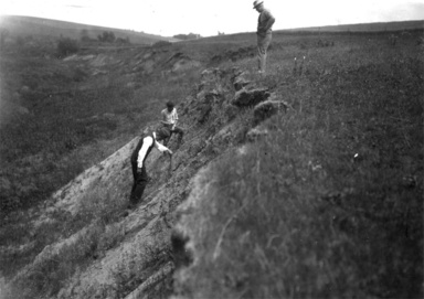 Kay George F. Kay, Frank Leverett, and Paul MacClintock atop/climbing a hill.